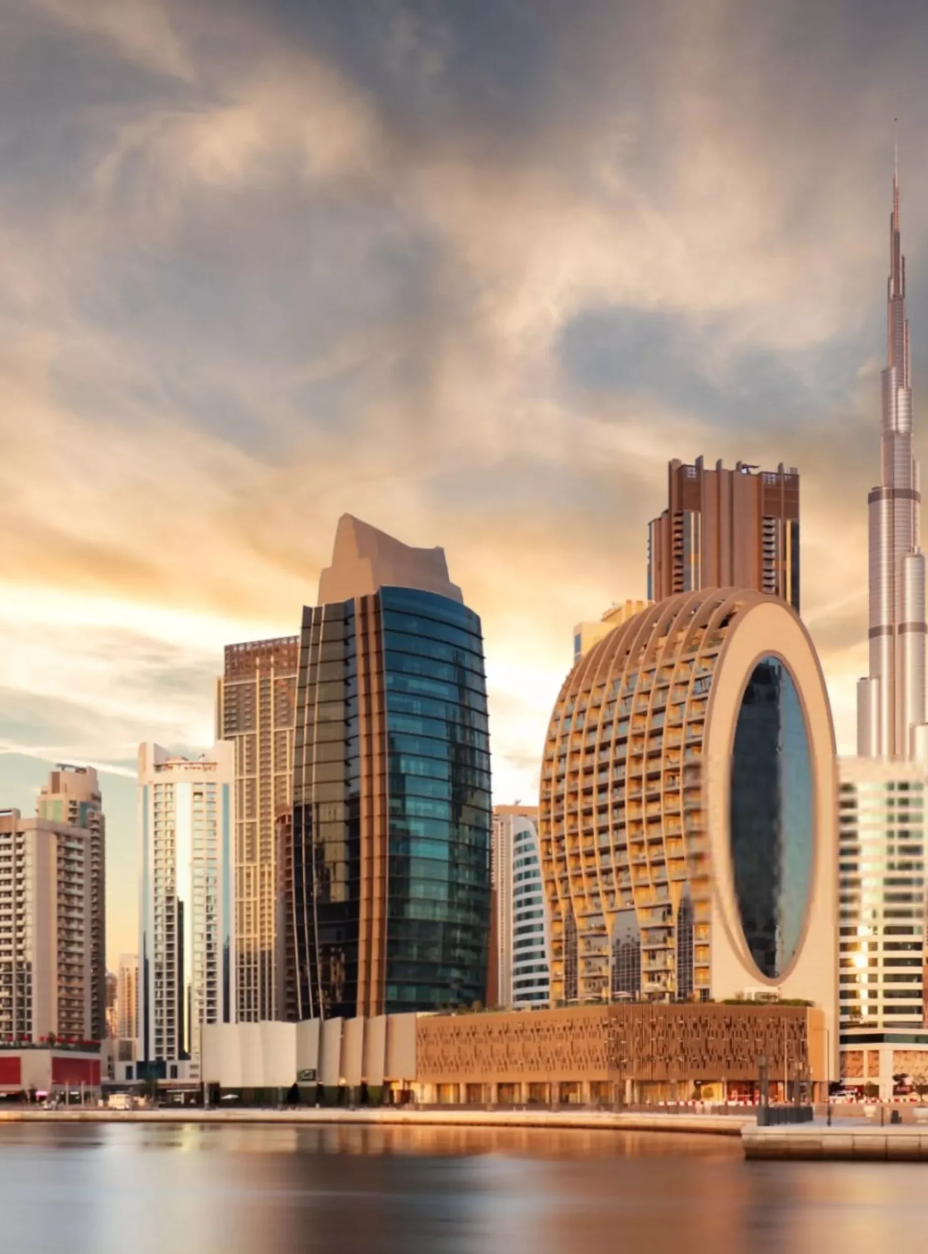 Panorama of skyline downtown Dubai at sunrise from Canal Cre-min