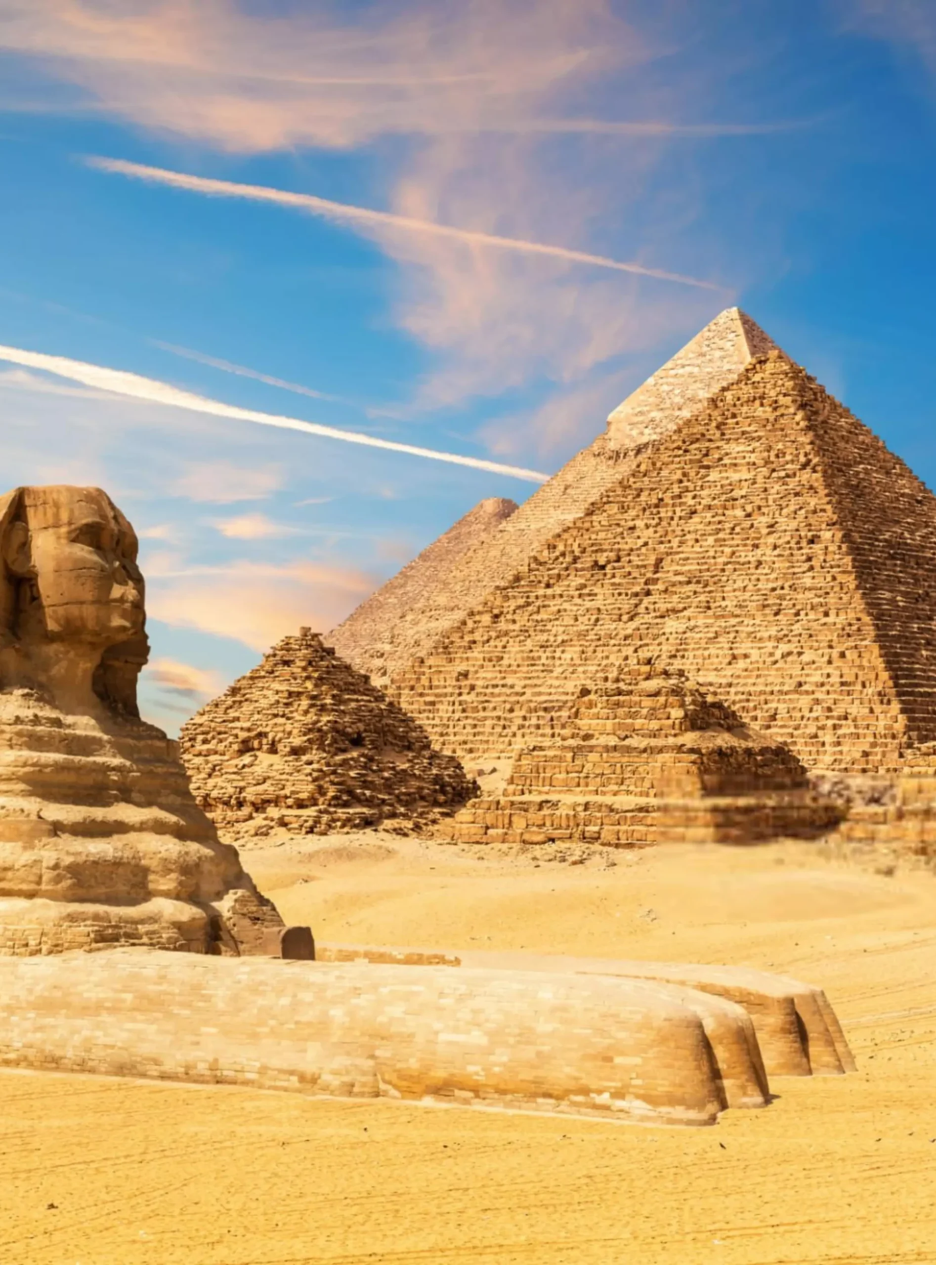 The Sphinx next to the Pyramids in the sands of Giza desert,-min